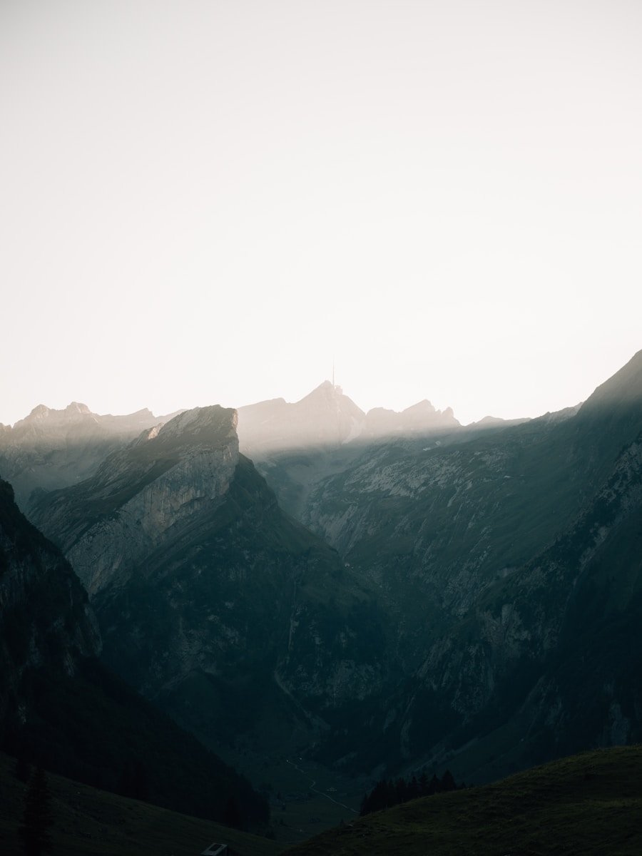 Sunlight breaking through mountain peaks at dawn